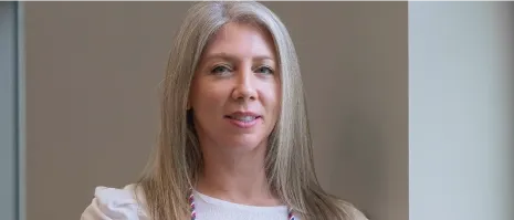 A woman wearing a medallion.